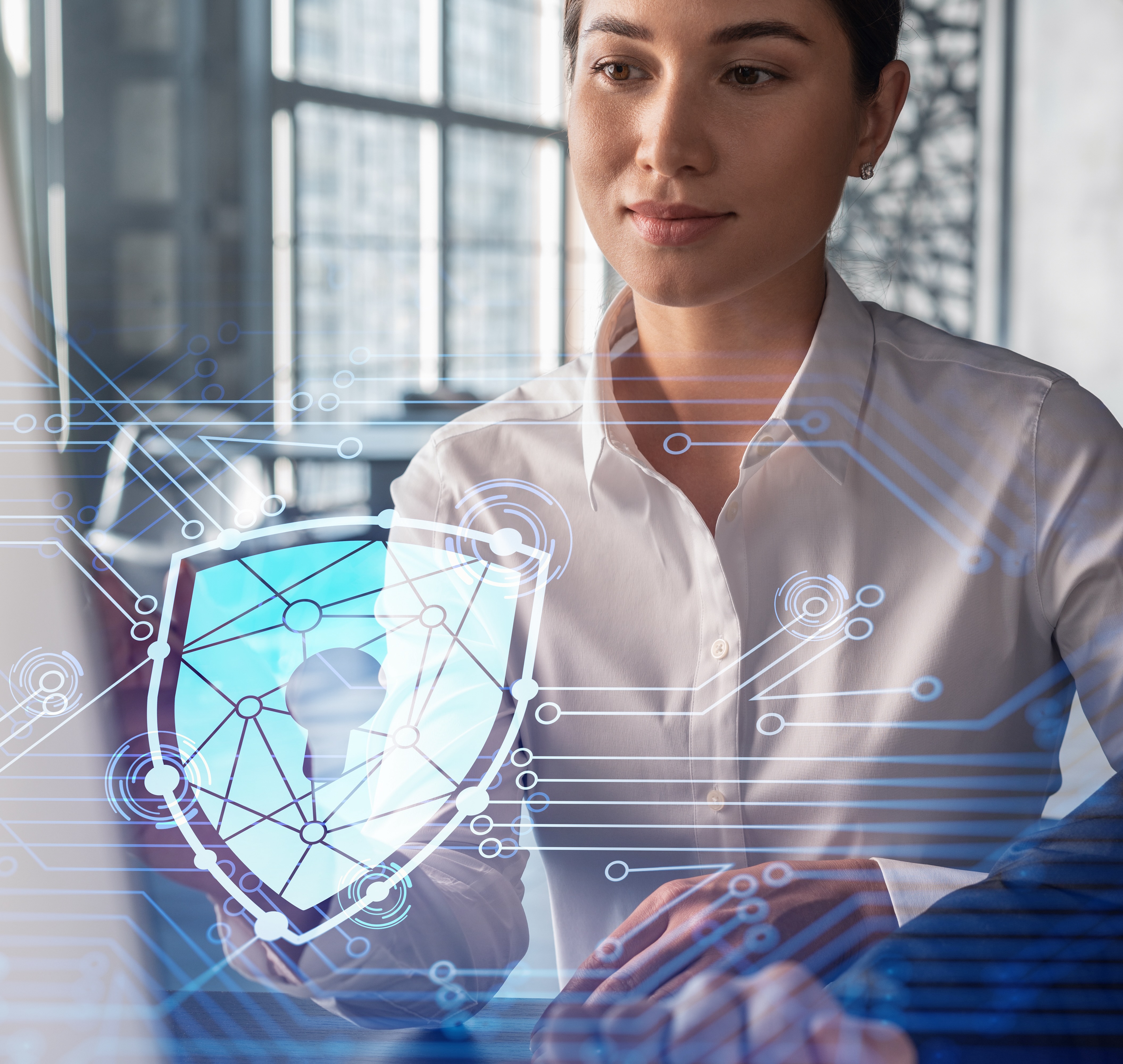 Businessman and businesswoman working together to protect clients confidential information and cyber security. IT hologram padlock icons over office background with panoramic windows.