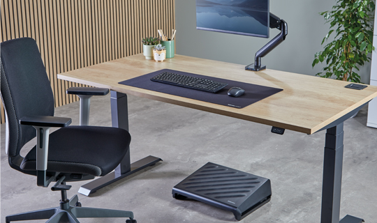 Office desk with keyboard, raised monitor, office chair