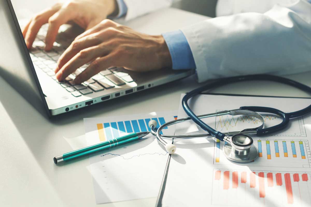 Doctor working with medical statistics and financial reports