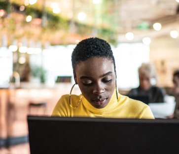 Peson looking at laptop.